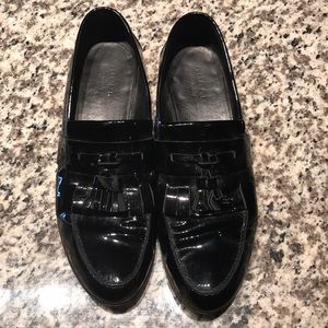 Men’s black patent Gucci loafers